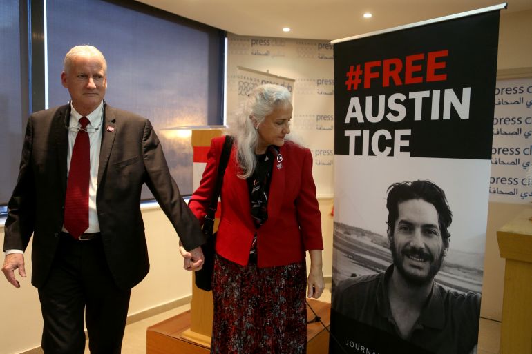 Marc and Debra Tice, parents of U.S. journalist Austin Tice, walk past a poster of their son after the news conference in Beirut