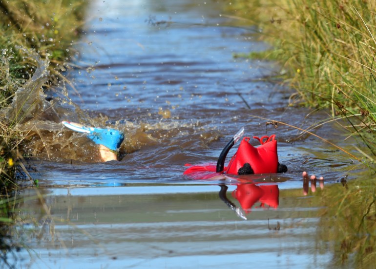 A competitor swims in the World Bog Snorkelling Championships, Llanwrtyd Wells, Powys, Wales A competitor swims in the World Bog Snorkelling Championships, Llanwrtyd Wells, Powys, Wales, Britain August 25, 2019. REUTERS/Rebecca Naden