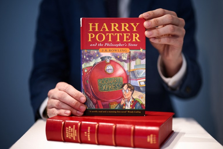 Rare first edition copy of 'Harry Potter and the Philosophers Stone' by British author J.K. Rowling at Christie's auction house in London A person holds a rare first edition and signed by the author copy of 'Harry Potter and the Philosophers Stone' by British author J.K. Rowling, which is to be put up for auction at Christie's auction house in London, Britain May 31, 2022. REUTERS/Henry Nicholls