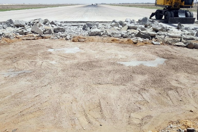 A heavy machine operates at the tarmac of Damascus International Airport