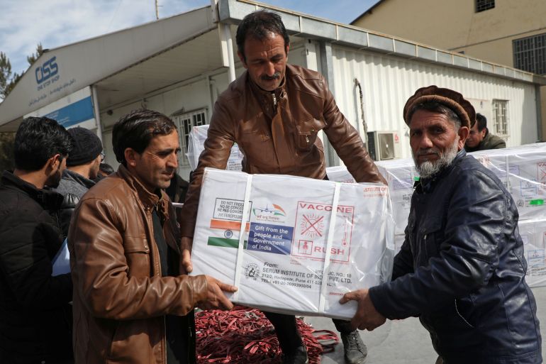 Workers from Afghan health ministry unload boxes containing vials of COVISHIELD, a coronavirus disease (COVID-19) vaccine donated by Indian government in Kabul