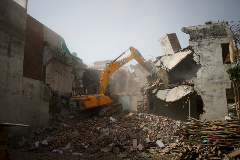 A bulldozer demolishes the house of a Muslim man that Uttar Pradesh state authorities accuse of being involved in riots last week, that erupted following comments about the Prophet Mohammed by India's ruling Bharatiya Janata Party (BJP) members, in Prayagraj, India, June 12, 2022. Authorities claim the house was illegally built. REUTERS/Ritesh Shukla
