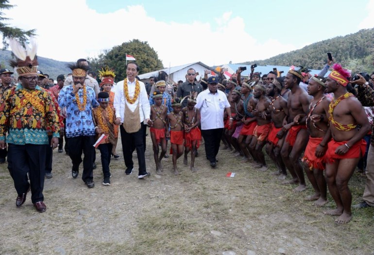 Indonesia's President Joko Widodo walk during his visit at Arfak mountain regency in West Papua province
