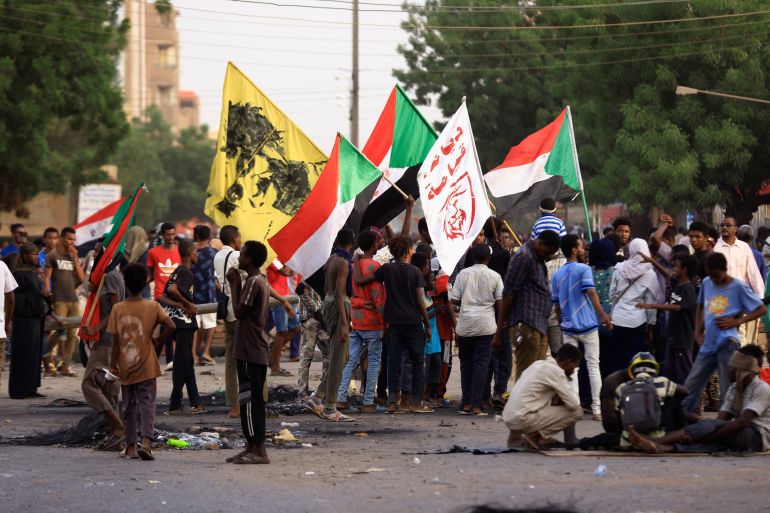 Protesters hold flags during sit-in rally in Khartoum