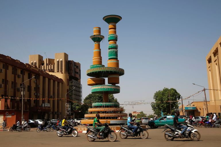 People ride their motorbikes around Filmmakers Square in Ouagadougou
