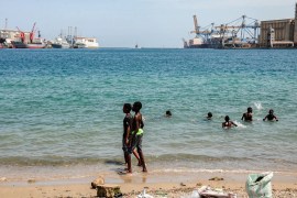 Children swim in the water near docked ships at Port Sudan on April 27, 2021. AFP/GETTY IMAGES