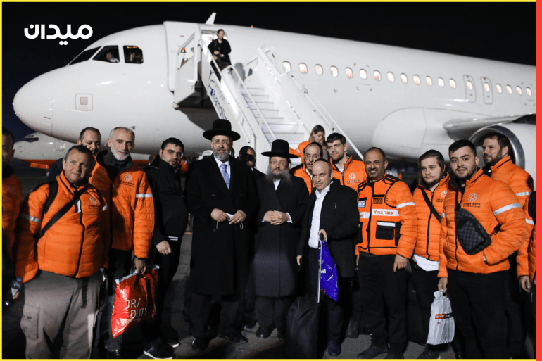 epa09815506 David Lau (C) Ashkenazi Chief Rabbi of Israel posses for a picture with United Hatzalah emergency medical organization special delegation to bring Ukrainian Jews who fled from the war to Israel at the Airport of Chisinau, Moldova, 10 March 2022. A group of 150 people were brought on a special rescue flight to bring Ukrainian Jews from Chisinau to Israel. Jewish aid organizations began assisting thousands of Jews in Ukraine since the beginning of the Russian invasion into the county, and are also facilitating the transfer of refugees who are fleeing fighting into Israel. About 300 Ukrainian Jews who fled through Poland and Moldova, as well as some 100 children who had been living in a Jewish orphanage, arrived in Israel on 06 March at the beginning of an operation organized by the Israeli government and Jewish Agency to allow Jewish immigrants fleeing the war in Ukraine into Israel. EPA-EFE/ABIR SULTAN