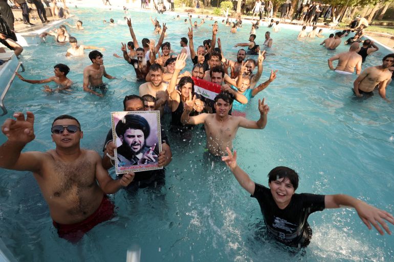 Supporters of Iraqi populist leader Moqtada al-Sadr swim as they protest inside the Republican Palace in the Green Zone, in Baghdad, Iraq August 29, 2022. REUTERS/Alaa Al-Marjani TPX IMAGES OF THE DAY