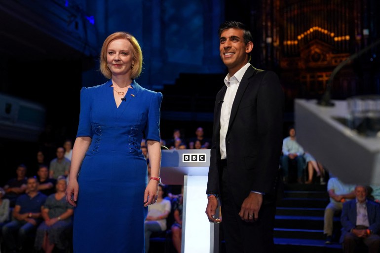 Candidates Rishi Sunak and Liz Truss stand before taking part in the BBC Conservative party leadership debate at Victoria Hall in Hanley, Stoke-on-Trent, Britain, July 25, 2022. Jacob King/Pool via REUTERS