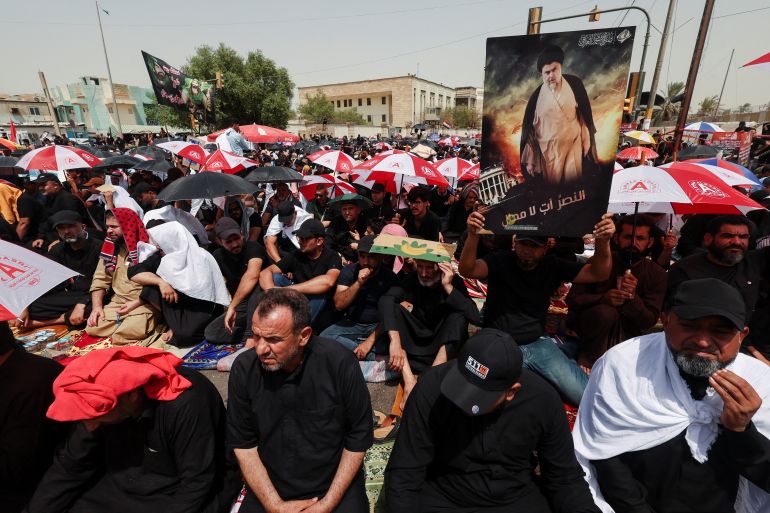 Supporters of Iraqi populist leader Moqtada al-Sadr gather for Friday prayers outside the parliament, in Baghdad