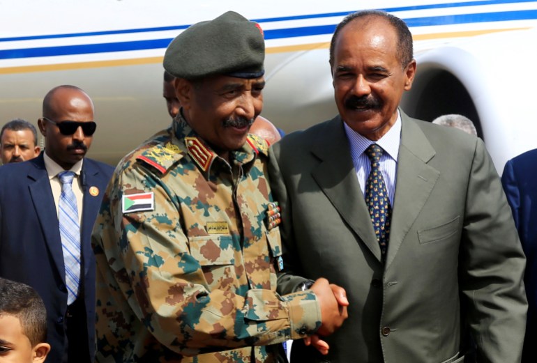 Eritrean President Isaias Afwerk is welcomed by Leader of Sudan's transitional council, Lieutenant General Abdel Fattah Al-Abdelrahman Burhan upon his arrival at Khartoum Airport