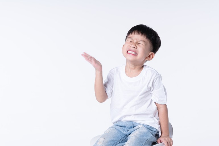 Asian boy about 4 year old hurting or hit himself with his palm as self punishment shutterstock_1898124841