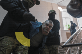 Officers of Russia's Federal Security Service escort Denis Nuryga, a purported member of the Aidar Battalion under the Ukrainian armed forces who reportedly surrendered in the course of Ukraine-Russia conflict, inside a court house in Rostov-on-Don, Russia May 19, 2022. REUTERS/Sergey Pivovarov