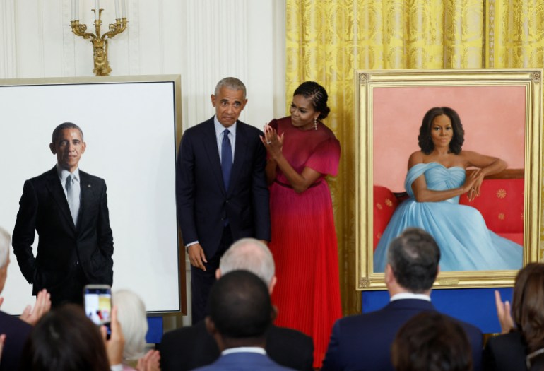 Former U.S. President Barack Obama and former first lady Michelle Obama react during the unveiling of their official White House portraits, painted by Robert McCurdy and Sharon Sprung, respectively, in the East Room of the White House, in Washington, U.S., September, 7, 2022. REUTERS/Evelyn Hockstein