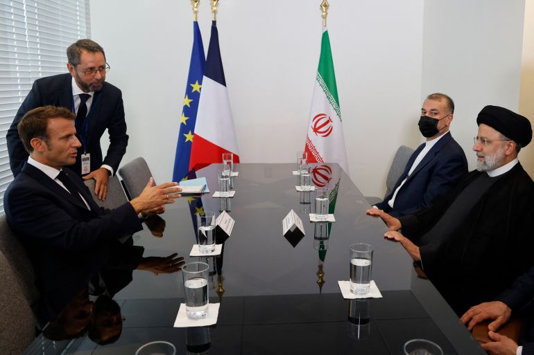 French President Emmanuel Macron (L) holds a bilateral meeting with Iranian President Ebrahim Raisi on the sidelines of the 77th United Nations General Assembly at UN headquarters in New York City on September 20, 2022. (Photo by Ludovic MARIN / AFP)