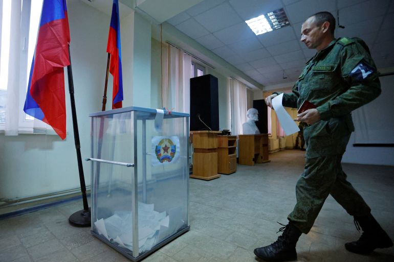 Service members of the self-proclaimed Luhansk People's Republic vote during a referendum in Luhansk
