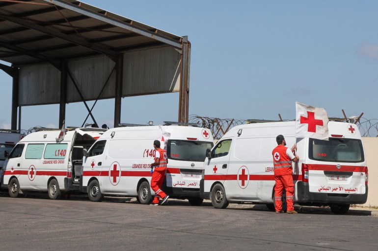Lebanese Red Cross vehicles are parked at the Lebanese-Syrian border crossing in Arida