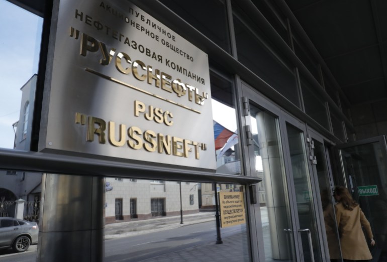 A woman enters the headquarters of Russian oil company Russneft in central Moscow