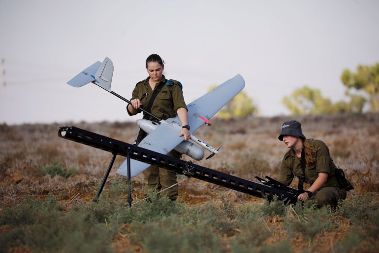 Israeli soldiers get ready to launch an unmanned aerial vehicle near the border with Gaza Strip