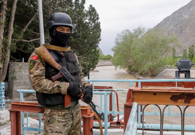 A service member of Kyrgyz special operations forces stands guard near a water distribution facility in Batken province