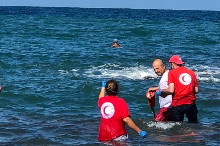 Members of Syrian Red Crescent work at a shoreline following a migrant boat, which according to Lebanese and Syrian officials, sank off the Syrian coast after sailing from Lebanon, in Tartous, Syria September 24, 2022. Courtesy of Syrian Red Crescent/Handout via REUTERS ATTENTION EDITORS - THIS IMAGE HAS BEEN SUPPLIED BY A THIRD PARTY. MANDATORY CREDIT.