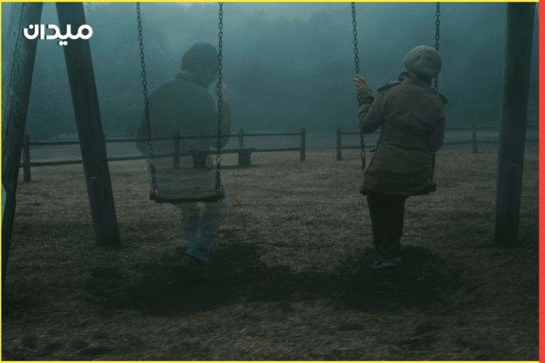 Concept of afterlife and memory for parents or lost love. Back view of woman sitting on a swing with ghost man near her outdoor in the park with fog. . Dead friend or husband concept. Life and death