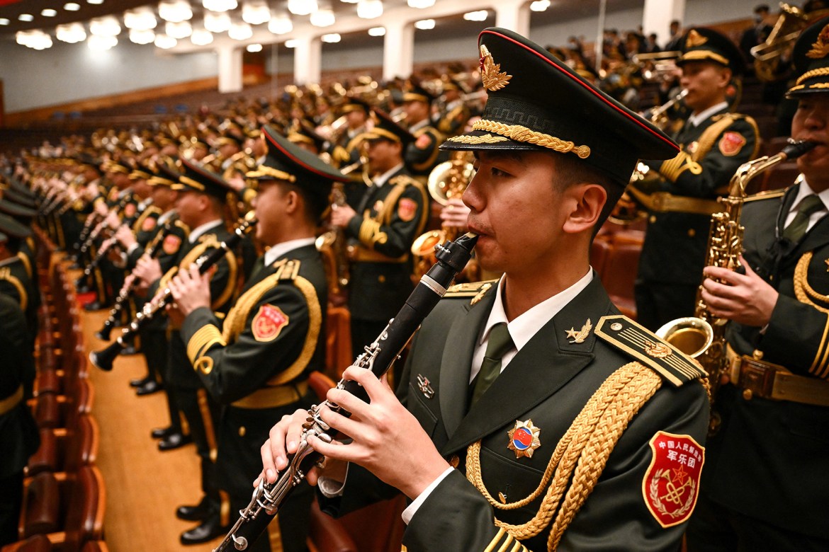 The People's Liberation Army band performs during the opening session. [Noel Celis/AFP]