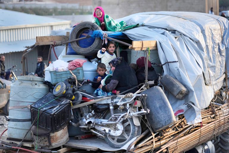 Syrian refugees sit in the back of a truck next to their belongings. Both international organisations and the refugees have remained wary about the conditions for return. [Hussein Malla/AP Photo]