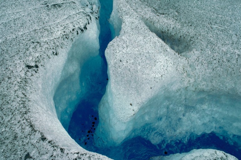 Water at Bottom of Crevasse of Glacier - stock photo