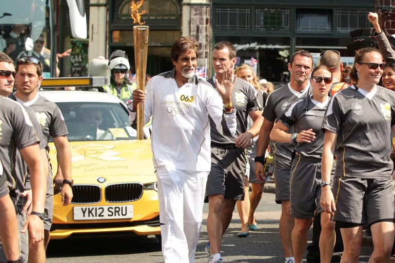Day 69 - The Olympic Torch Continues Its Journey Around The UK LONDON, UNITED KINGDOM - JULY 26: In this handout image provided by LOCOG, Bollywood Actor Torchbearer 063 Amitabh Bachchan carries the Olympic Flame on the Torch Relay leg between The City of London and Southwark, during Day 69 of the London 2012 Olympic Torch Relay on July 26, 2012 in London, England. The Olympic Flame is now on Day 69 of a 70-day relay involving 8,000 torchbearers covering 8,000 miles. (Photo by LOCOG via Getty Images) gettyimages-467896138
