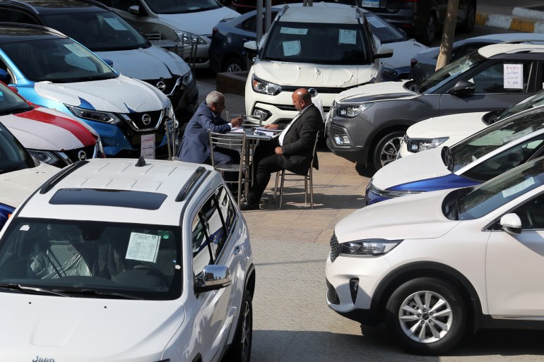 A customer sits with a sales representative at a car dealership where dozens of vehicles are on display in Cairo, Egypt, March 7, 2019. Picture taken March 7, 2019. REUTERS/Mohamed Abd El Ghany