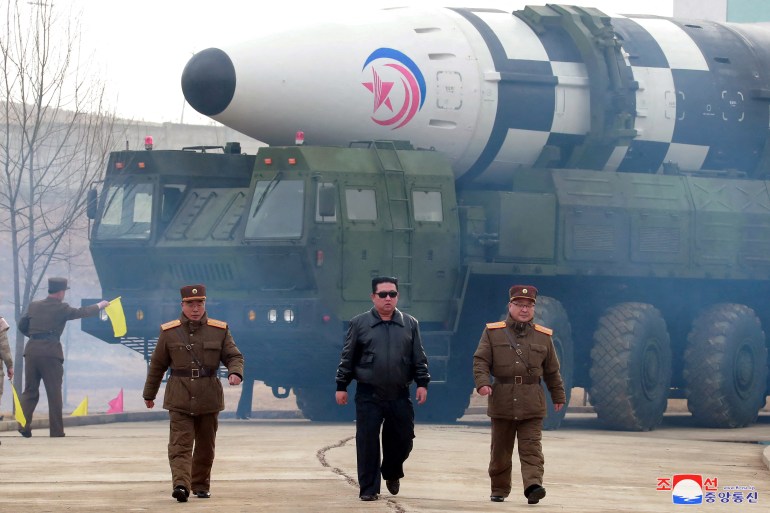 North Korean leader Kim Jong Un walks away from what state media report is a "new type" of intercontinental ballistic missile (ICBM)