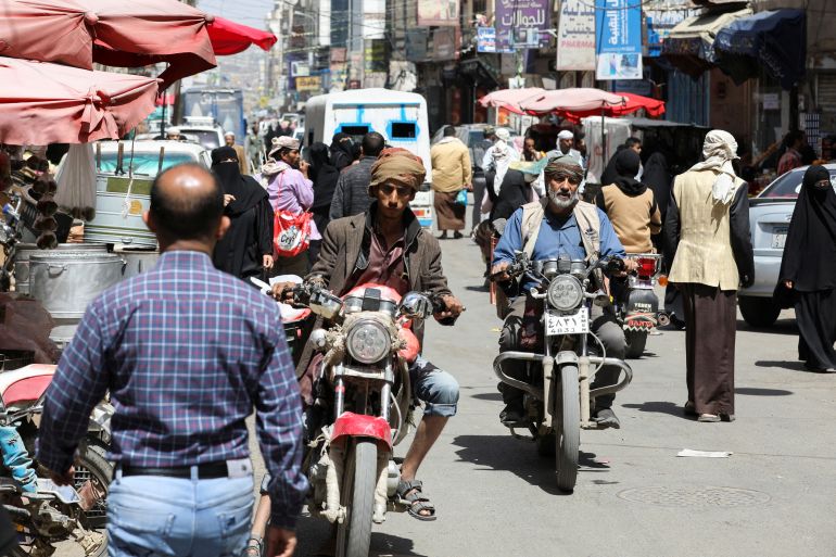 People ride on motorbikes on a street hours before a two-month nationwide truce takes effect, in Sanaa