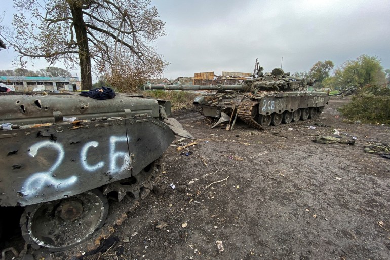 Abandoned Russian tanks are seen in the village of Kurylivka