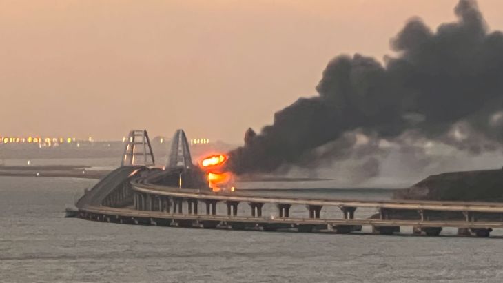 A view shows a fire on the Kerch bridge at sunrise in the Kerch Strait, Crimea
