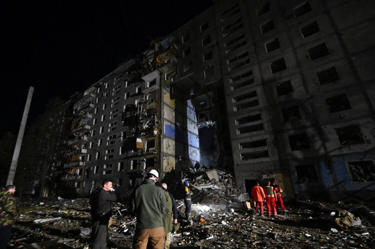 Rescuers work at a site of a residential building heavily damaged by a Russian missile strike in Zaporizhzhia