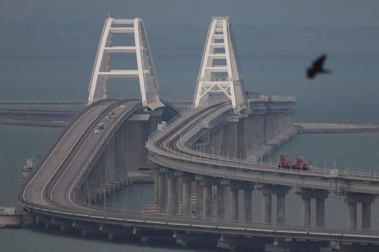 Passenger cars drive on the Kerch bridge, after an explosion destroyed part of it, in the Kerch Strait, Crimea