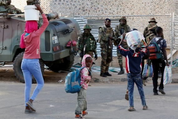 Children walk past regional ECOWAS troops in Banjul