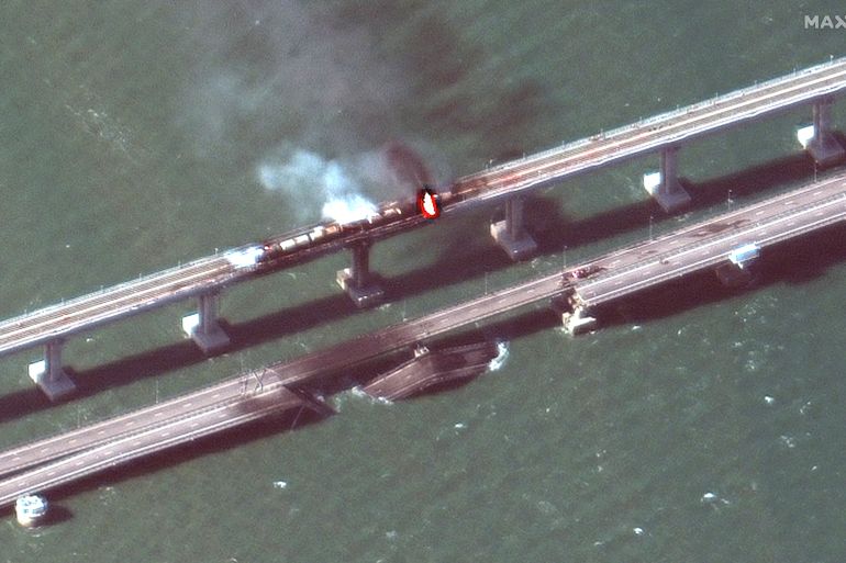 A satellite image shows a close up view of smoke rising from a fire on the Kerch bridge in the Kerch Strait, Crimea, October 8, 2022. Maxar Technologies/Handout via REUTERS ATTENTION EDITORS - THIS IMAGE HAS BEEN SUPPLIED BY A THIRD PARTY. MANDATORY CREDIT. NO RESALES. NO ARCHIVES. MUST NOT OBSCURE LOGO