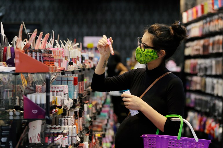 Sao Paulo, SP, Brazil - June 10, 2020: A pregnant woman shop in a cosmetics store at 25 de marco street, downtown area.