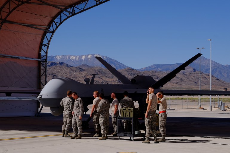 Maintenance crews cluster around an MQ-9 Reaper drone as they prepare it for a training mission at Creech Air Force Base in Nevada May 19, 2016. Picture taken May 19, 2016. REUTERS/Josh Smith