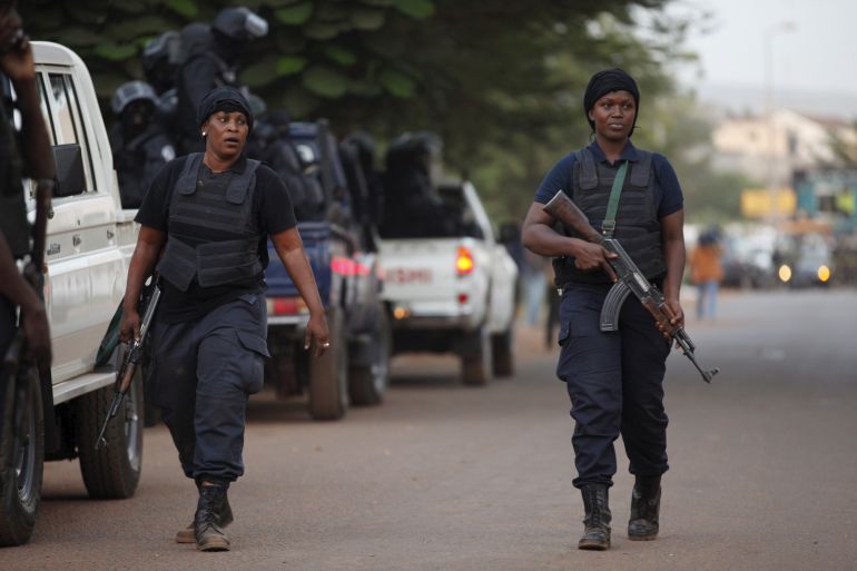 Malian police walk in front of the Radisson hotel in Bamako