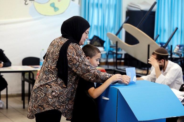 People cast their vote in Israel's general election in a polling station in Taibe