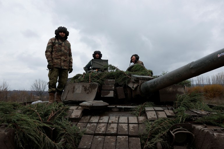 Ukrainian soldiers fires a round from a former Russian tank, in Bakhmut