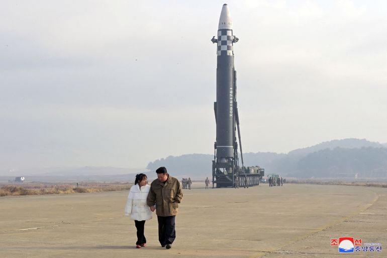 North Korean leader Kim Jong Un walks away from an intercontinental ballistic missile (ICBM)
