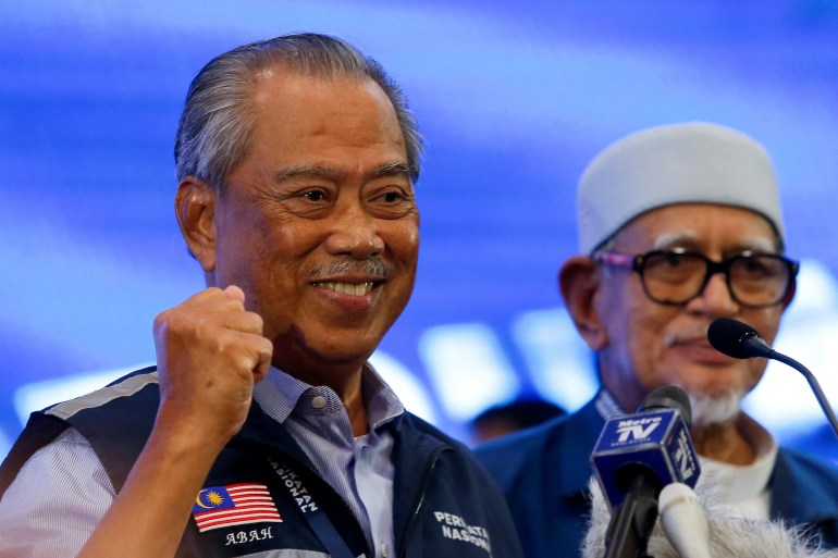 Malaysian former Prime Minister and Perikatan Nasional chairman Muhyiddin Yassin gestures during a news conference after Malaysia's 15th general election in Shah Alam