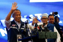Malaysian former Prime Minister and Perikatan Nasional Chairman Muhyiddin Yassin waves as he attends a new conference after Malaysia's 15th general election in Shah Alam