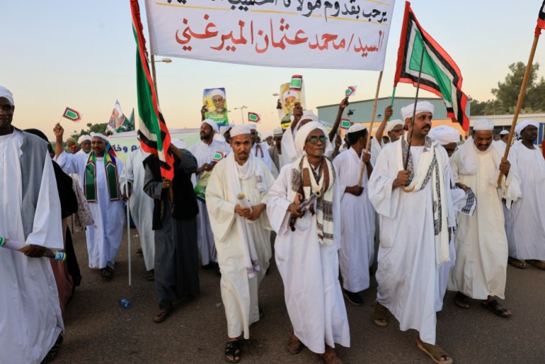 Supporters of Sudanese political and religious leader gather at the airport to welcome him in Khartoum