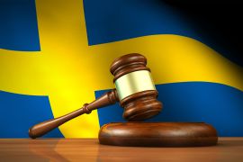 Swedish Law And Justice Concept - stock photo Swedish law and justice concept with a 3d rendering of a gavel on a wooden desktop and the flag of Sweden on background. gettyimages-472902878