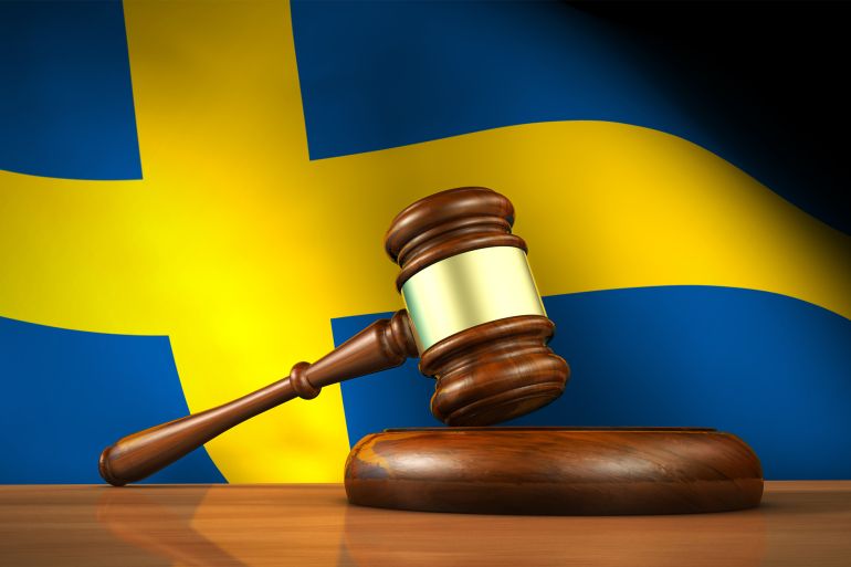 Swedish Law And Justice Concept - stock photo Swedish law and justice concept with a 3d rendering of a gavel on a wooden desktop and the flag of Sweden on background. gettyimages-472902878